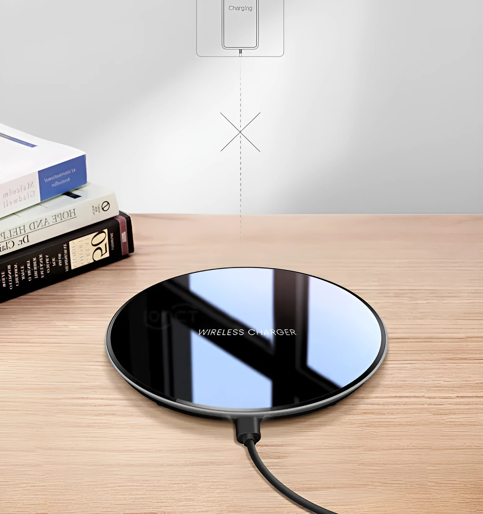 Black QI wireless charging pad on a desk, showing its non-slip silicone base.