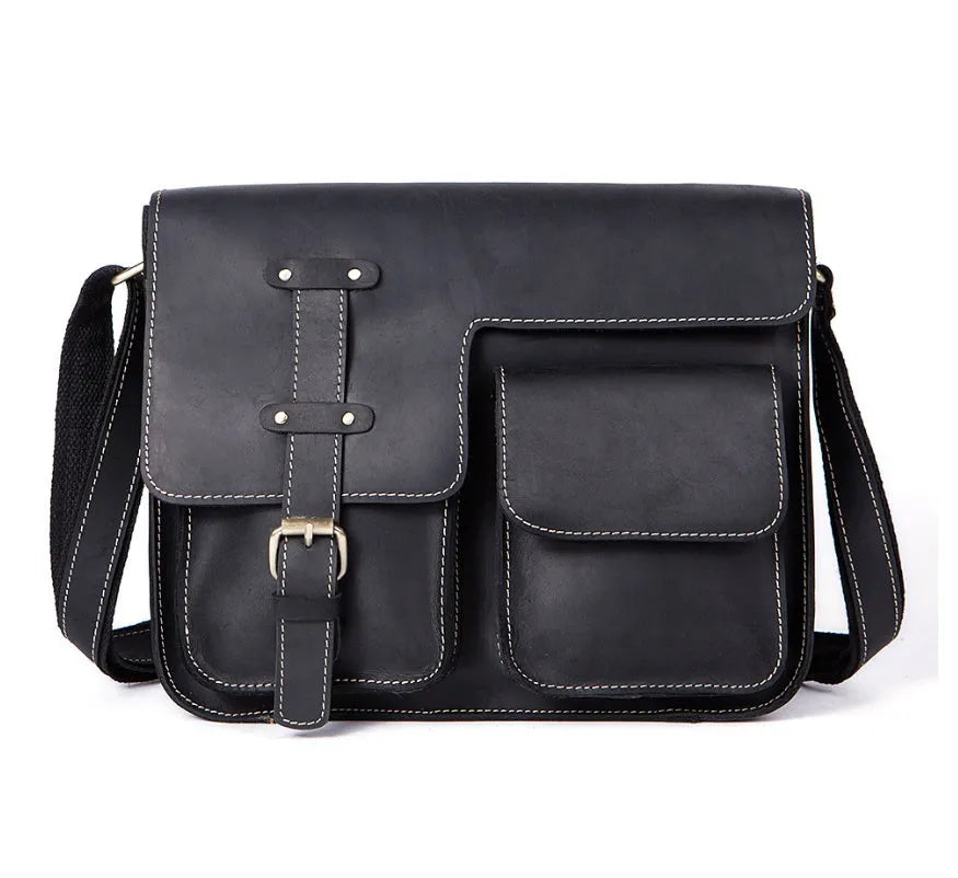 Brown full-grain leather vintage messenger bag with brass buckle, shown open to reveal padded laptop sleeve and internal pockets.
