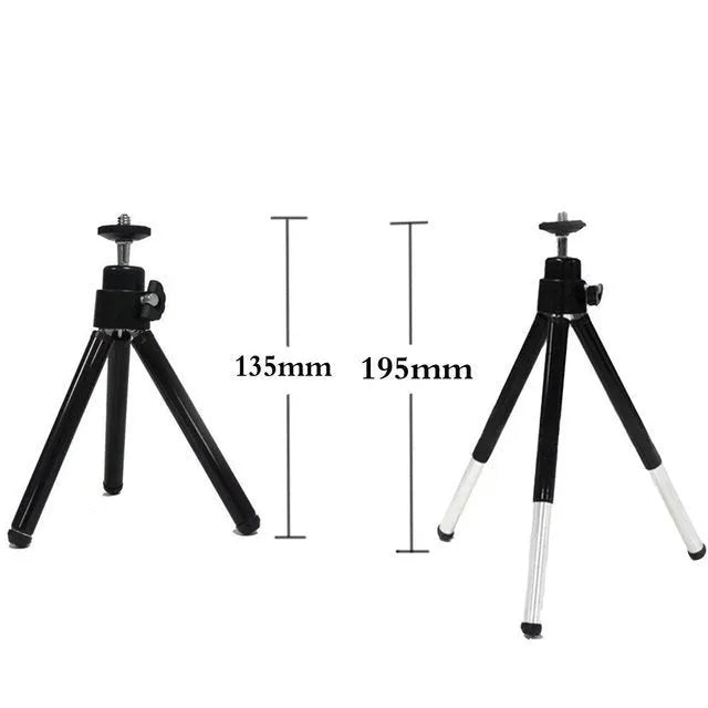 Mini aluminium tripod with extended legs and a black U-shaped phone clip attached
