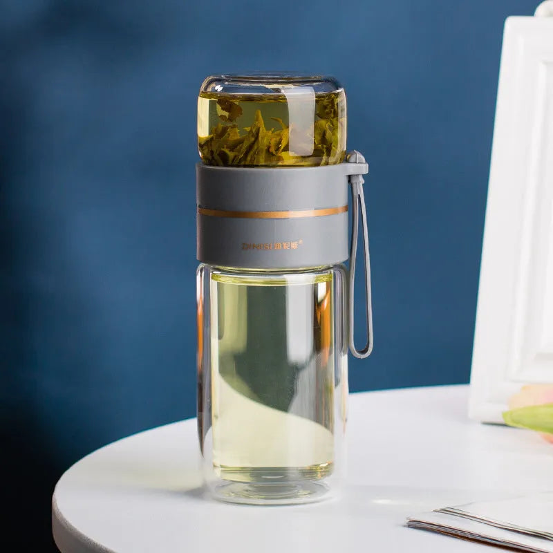 Glass water bottle with tea infuser filter showing double wall construction and portable rope