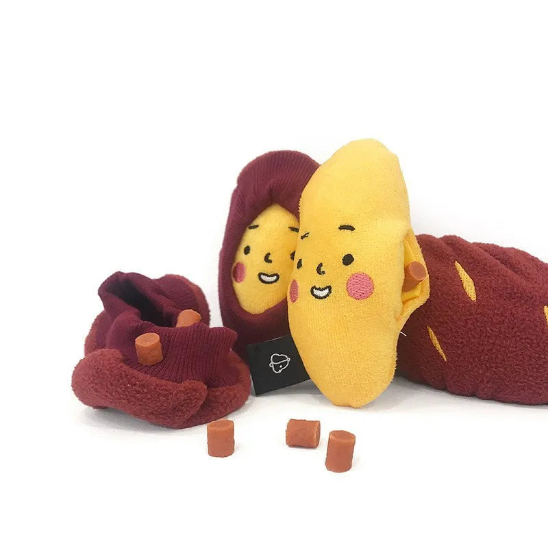 Red sweet potato-shaped dog toy with hidden food pockets and wrap-up design for treat puzzles.
