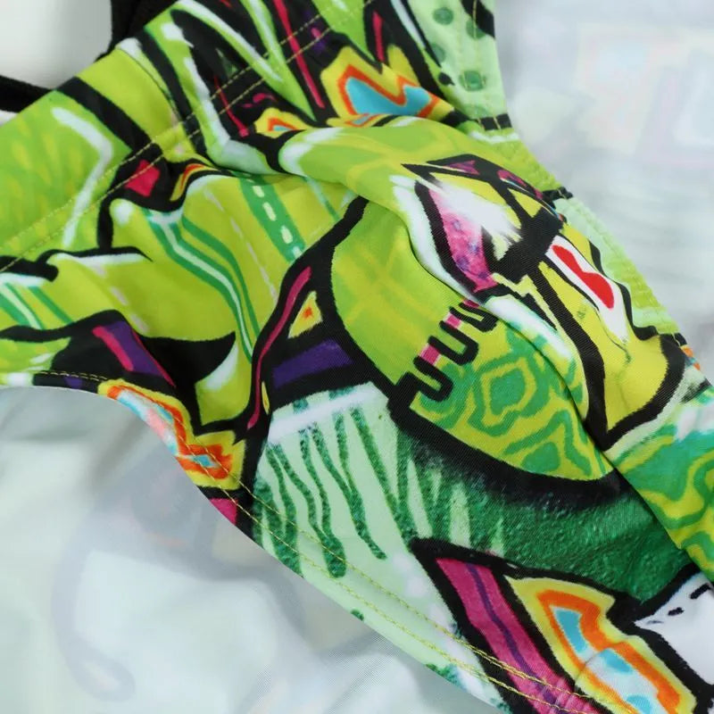 Men's printed polyester swimming trunks on a size chart, showing colour options: Cyber, Ice Cream, Streamer, Skull.