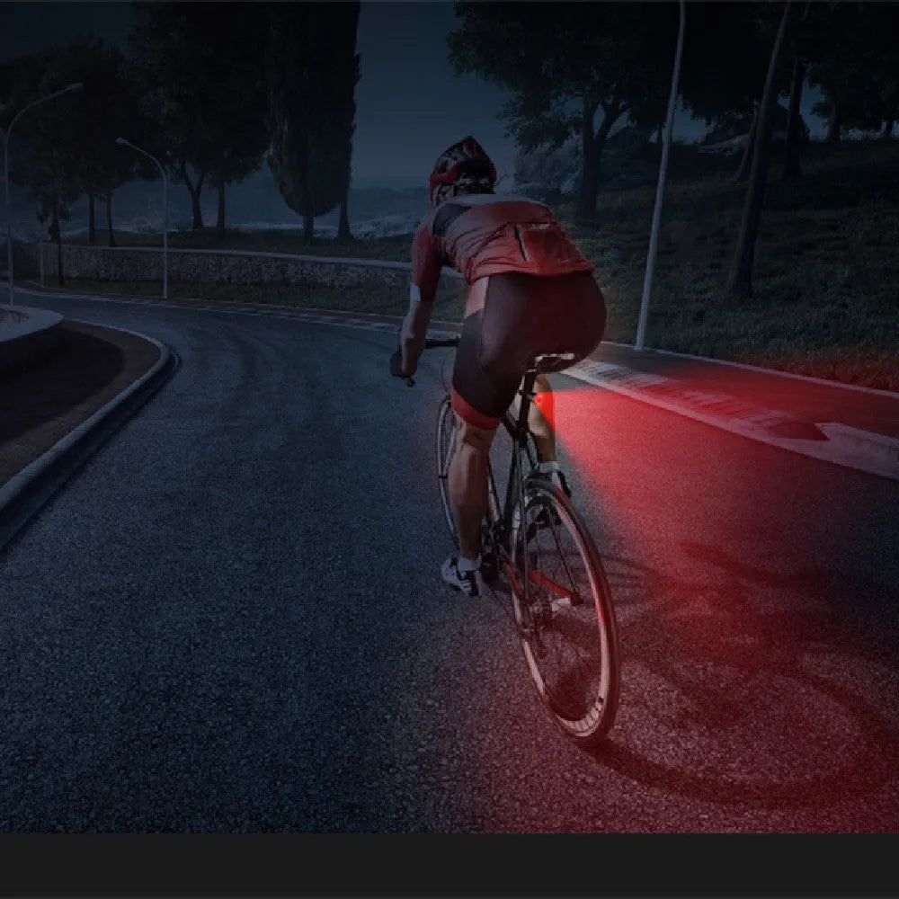 Black aluminium alloy smart bicycle tail light showing USB port and brake-sensing sensor.