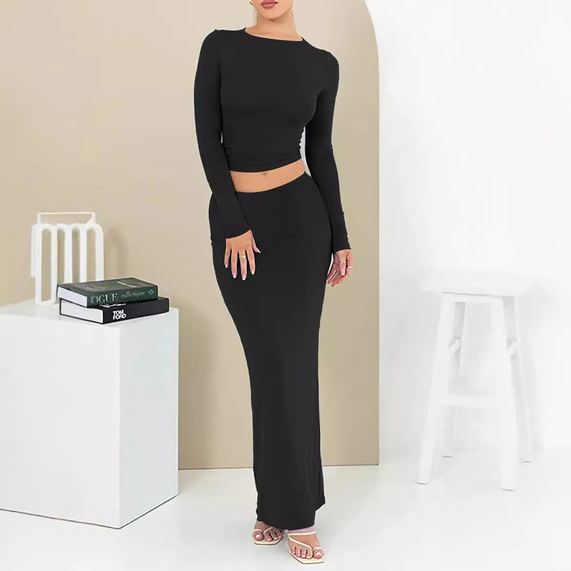 Women's black crop top and long skirt two-piece set with three-quarter sleeves and exposed navel design