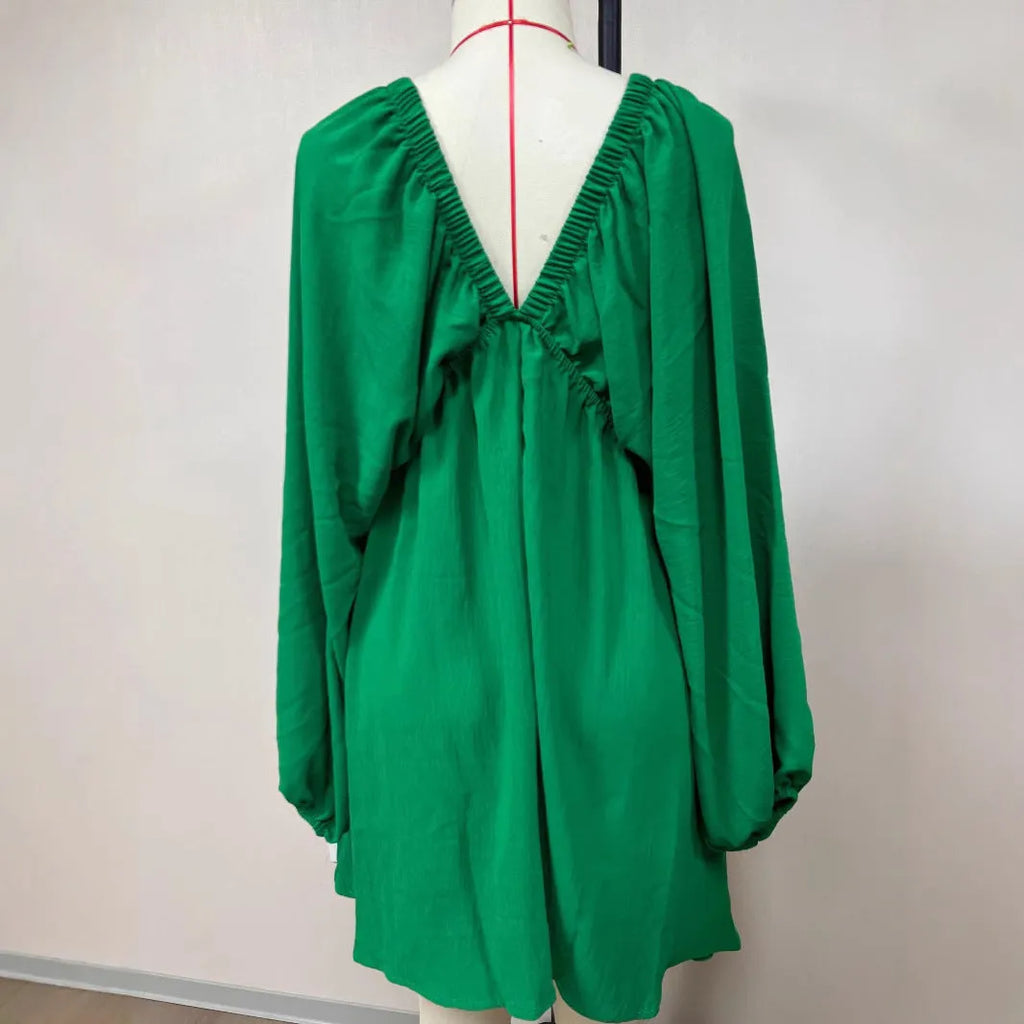 Solid colour V-neck dress with long puff sleeves and a mid-waist swing skirt.