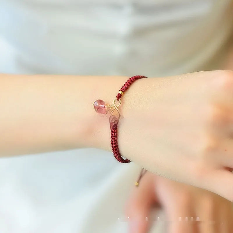 Women's Natural Strawberry Quartz bracelet with fruit-shaped cherry beads on a wrist.