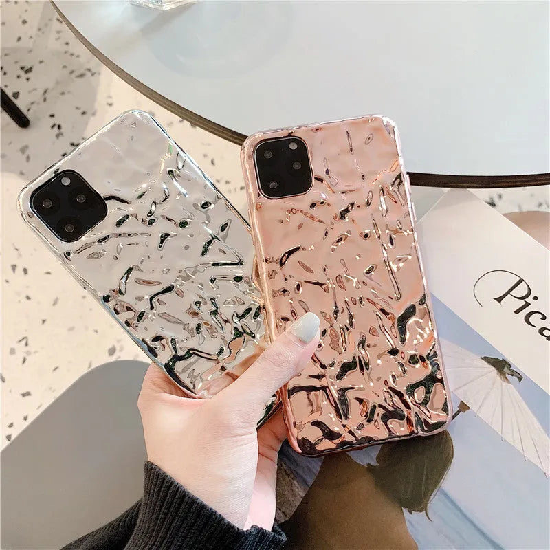 Rose gold folded TPU back cover case for iPhone on a plain background.