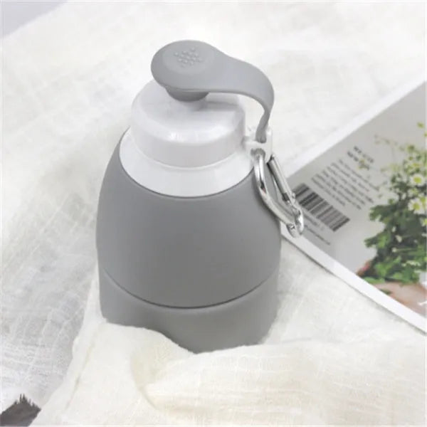 Blue silicone folding water bottle shown expanded and collapsed next to backpack for size comparison