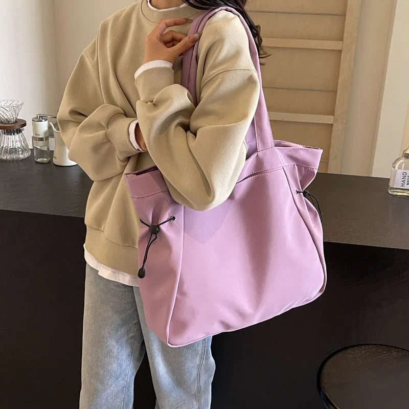 Soft Oxford cloth folding tote bag in five colour options showing shoulder carry design