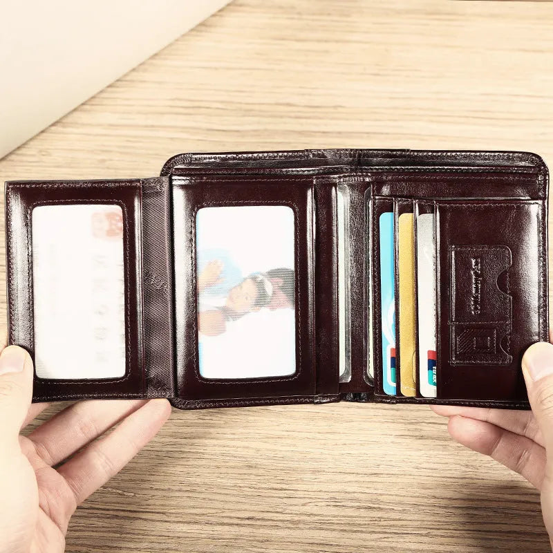 Men's black genuine leather bi-fold wallet open, showing eight card slots, a note compartment, and a zipped coin pouch.