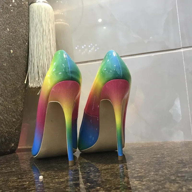 Rainbow coloured patent leather high heel shoes with a pointed toe and a thin stiletto heel.