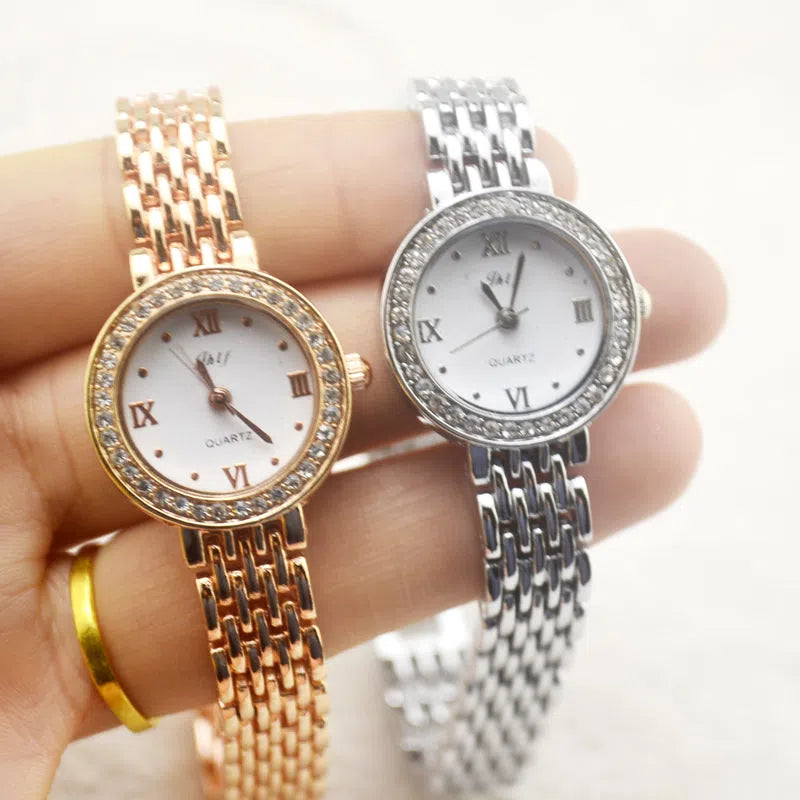 Gold alloy fashion quartz watch with rhinestone details, 20mm dial, and ordinary glass mirror on a neutral background