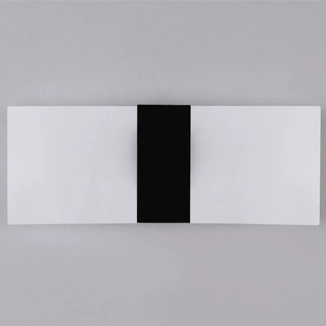 Modern acrylic wall-mounted LED bedside lamp in silver finish showing warm light illumination