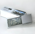 Dot matrix LCD car clock with suction cup on dashboard showing time and date