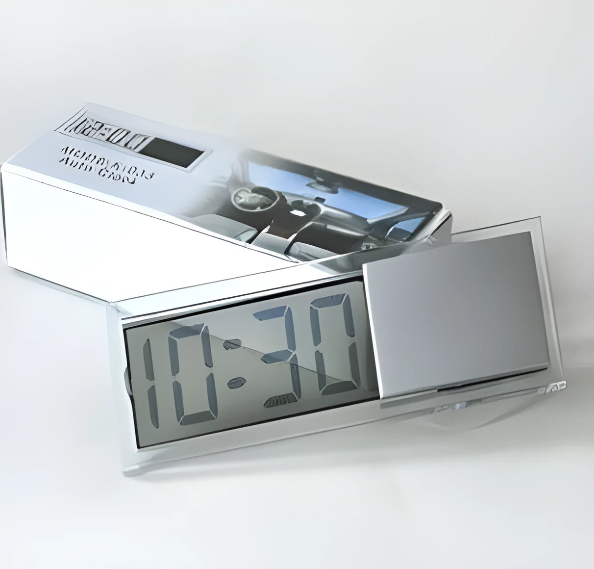 Dot matrix LCD car clock with suction cup on dashboard showing time and date