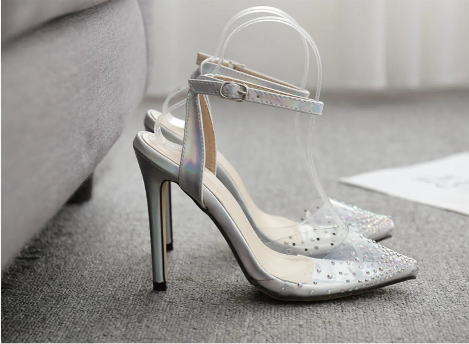 Women's pointed toe stiletto sandals with a diamond detail on a glossy PVC upper.