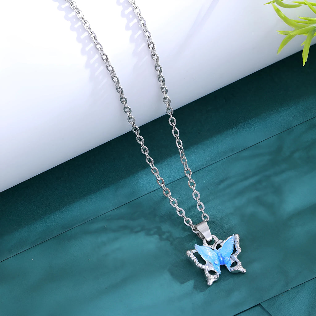 Blue three-dimensional butterfly pendant necklace for women on a light background