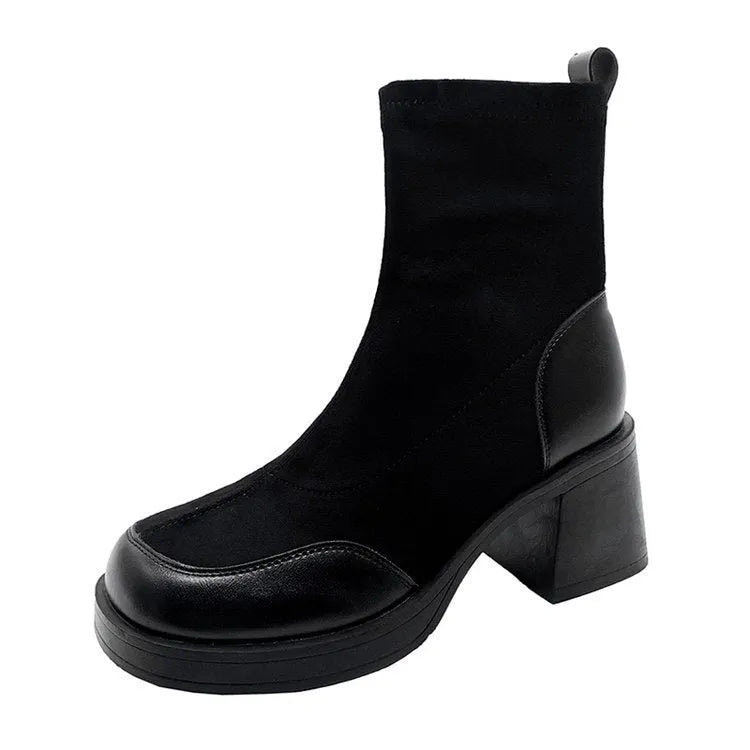 Women's black Martin boots with chunky heel and thick rubber sole, side view