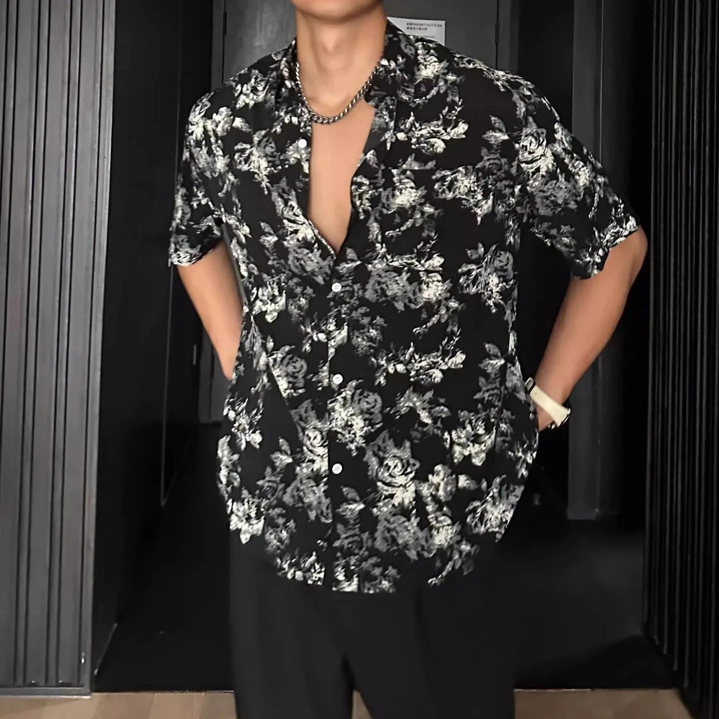 A loose-fitting, short sleeve casual shirt with a floral print, shown in a cardigan style.