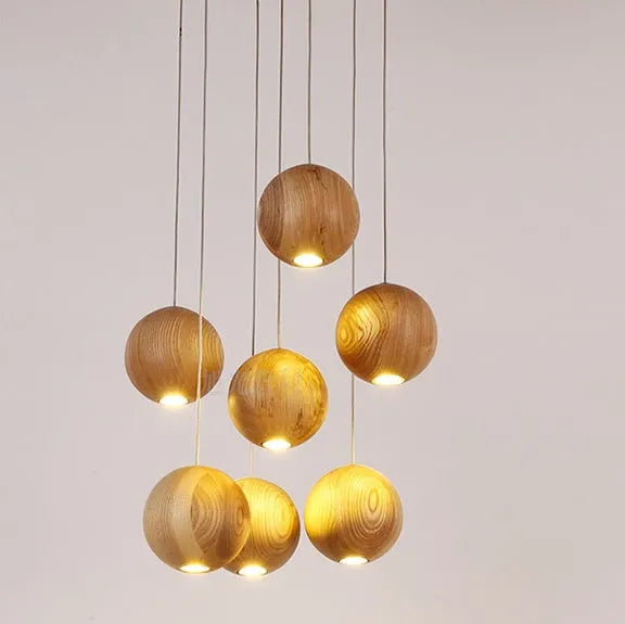 Nordic solid wood ball pendant chandelier with an adjustable cord hanging from a wooden disc.