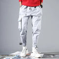 Loose cotton cargo pants with velcro straps in purple, white, beige, black, or grey, nine-length, sizes M-3XL.