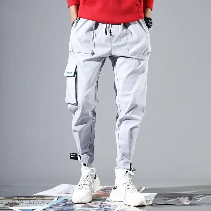 Loose cotton cargo pants with velcro straps in purple, white, beige, black, or grey, nine-length, sizes M-3XL.