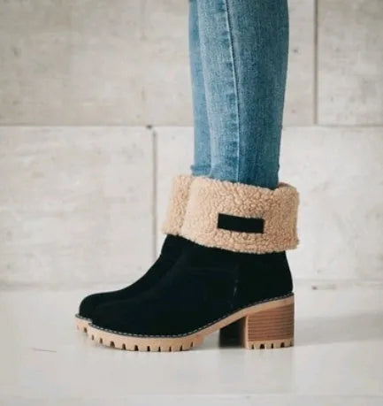 Women's black suede mid-tube snow boots with a thick heel and round toe on a waterproof platform.