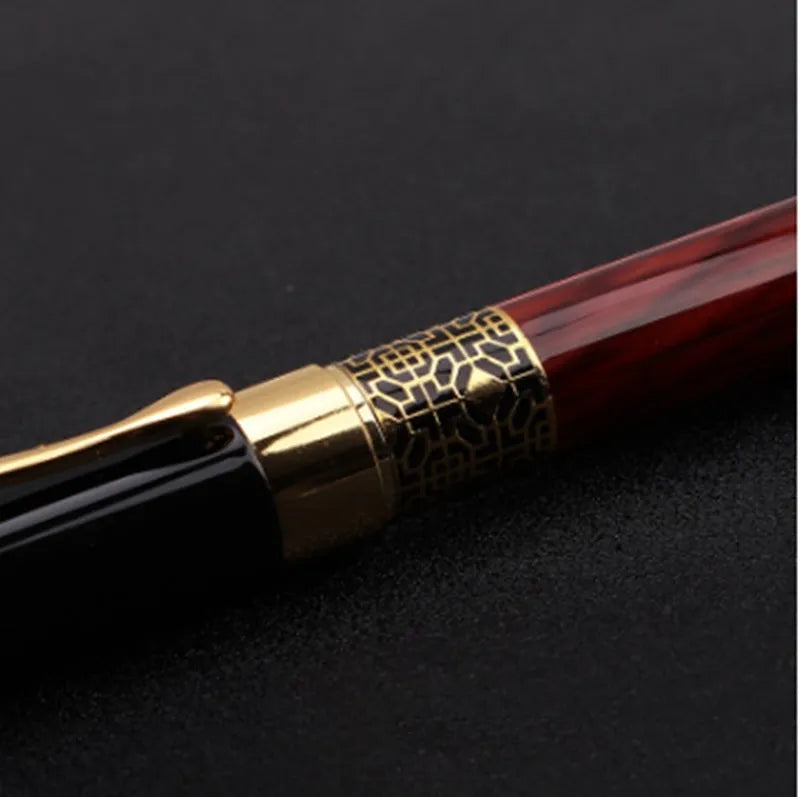 Metal fountain pen with imitation mahogany wood grain finish and 0.5mm nib on a desk setup