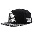 Adjustable black cotton baseball cap with embroidered lettering on the front, showing dome crown shape.
