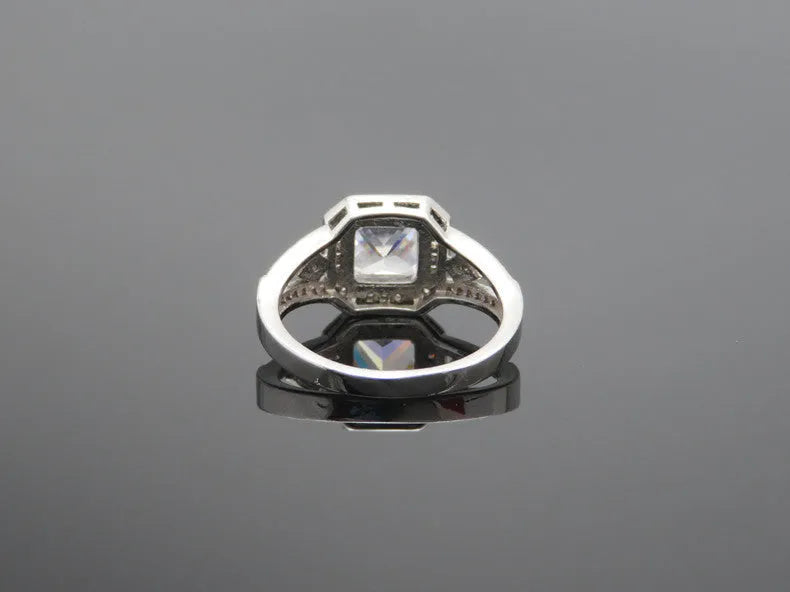 Platinum-colour hollow geometric ring with an inlaid cubic zirconia stone, shown from the side.