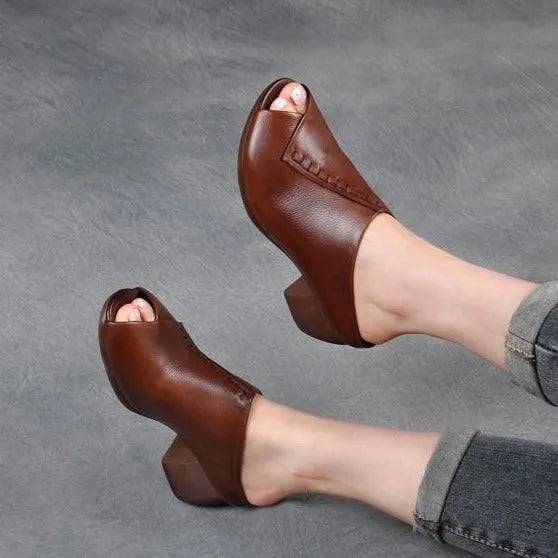 Women's black square heel peep-toe slippers with a fish mouth scaffold design on a rubber sole.