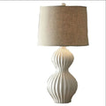 American country style ceramic table lamp with a white fabric shade, shown on a wooden table.