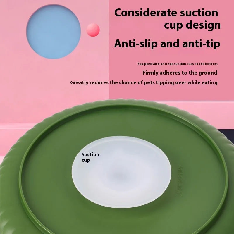 Grey pet bowl with a rotating windmill-pattern silicone licking mat for slow feeding on a kitchen floor.