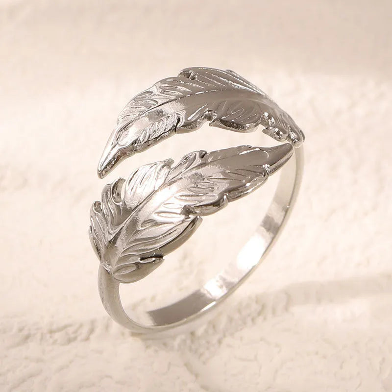 Adjustable stainless steel feather ring showing electroplated finish in silver or gold colour option