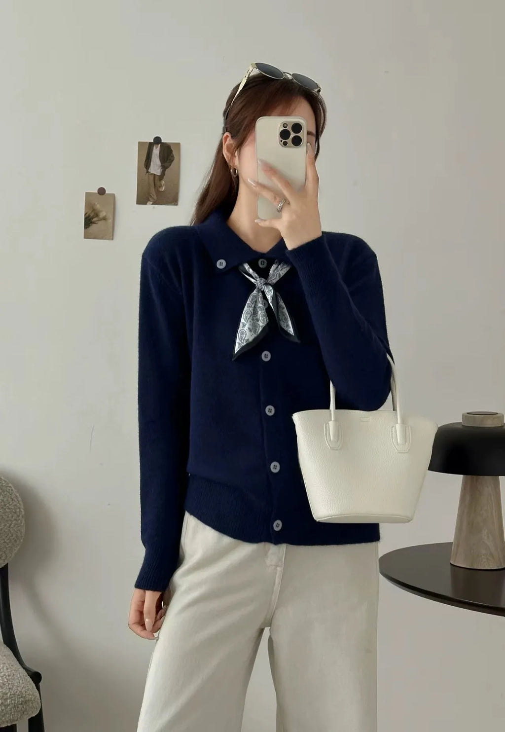 Milky white cardigan sweater with a lapel scarf collar and spliced knit detailing.