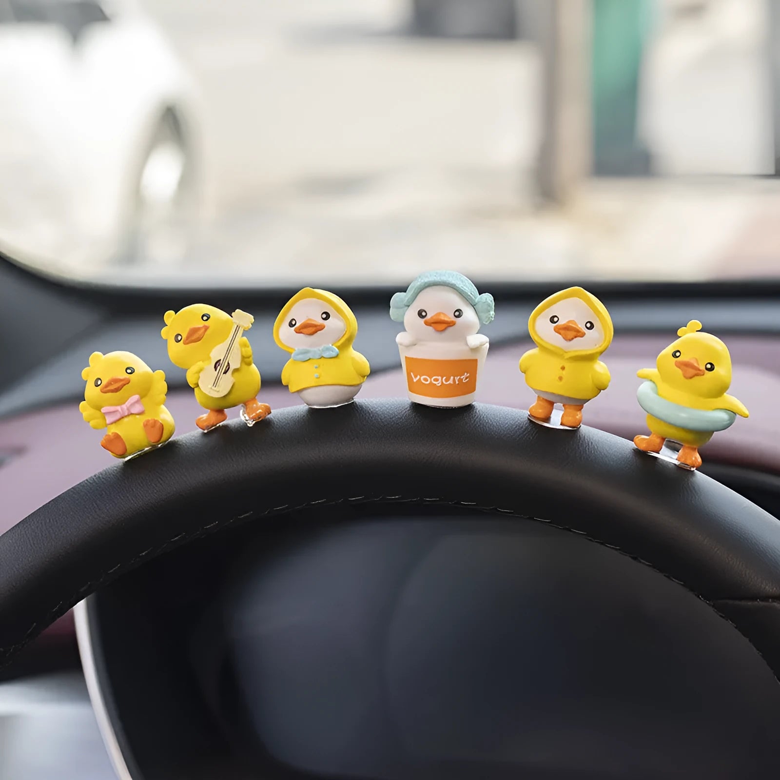 PVC cartoon duckling car decoration set with six ducks and one sign on a car dashboard