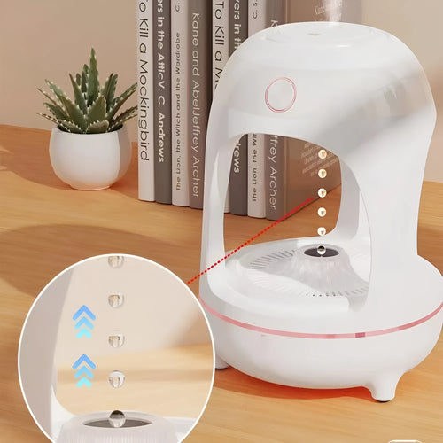 Rose gold and white levitating water drops humidifier with LED light on desk