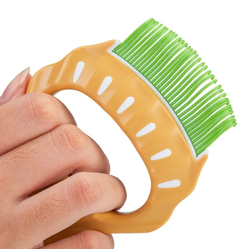 Green shell-shaped plastic pet grooming brush with bent wire bristles and anti-slip handle on a white background.