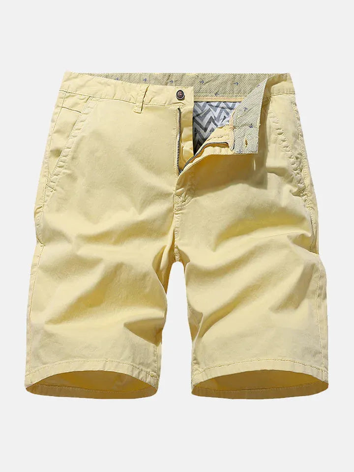 Men's loose-fit blue printed denim shorts with an elastic waistband on a neutral background.