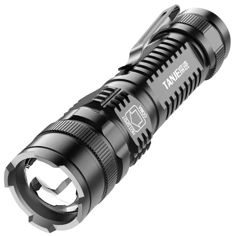 Small black aluminium telescopic LED flashlight with clip, showing zoom adjustment and button switch.