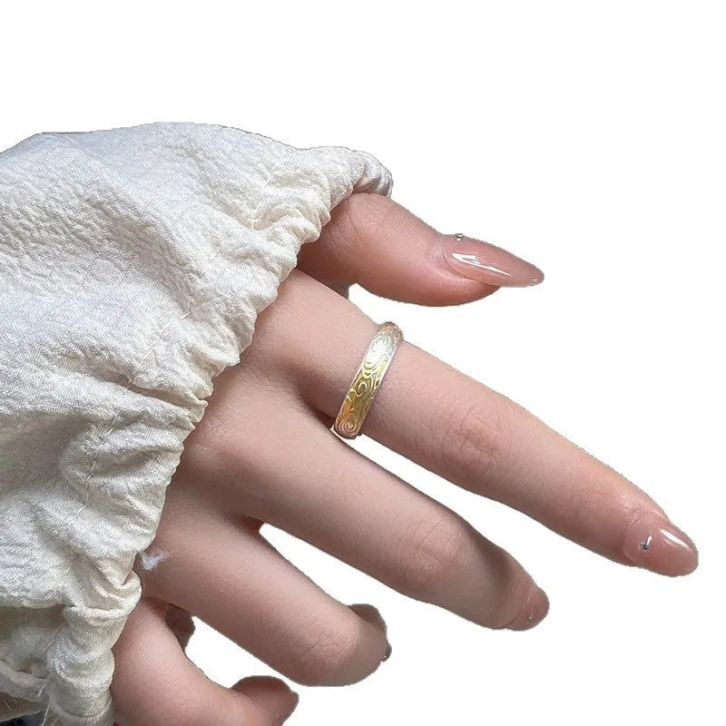 Geometric open-mouth silver and gold ring with a Xiangyun cloud pattern on a white copper band.