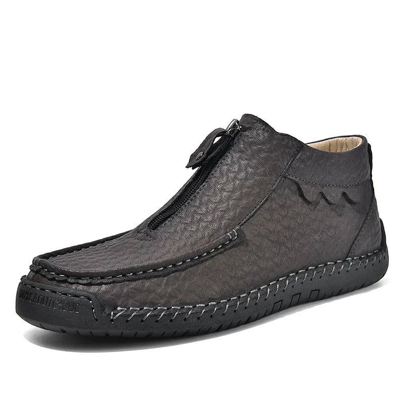 Men's black slip-on loafers with round toe and rubber sole on a plain background.