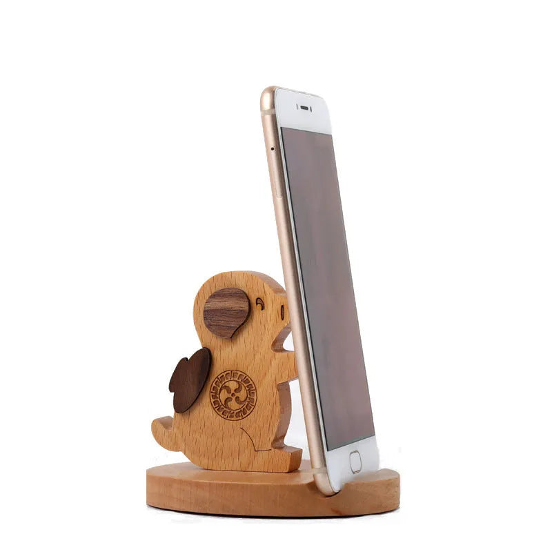 A decorative resin mobile phone stand holding a smartphone, shown in an animal design variant.