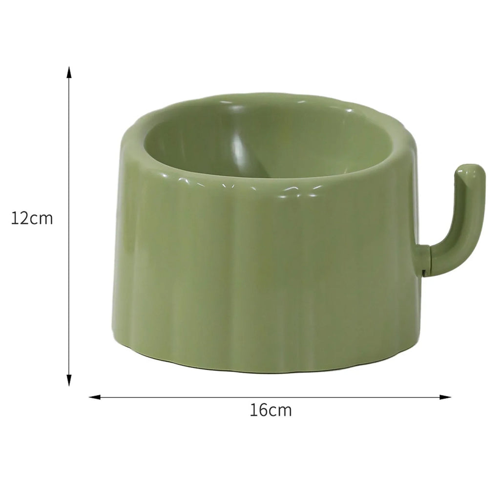 Solid green cat bowl with cactus pattern and anti-slip base on a kitchen floor.