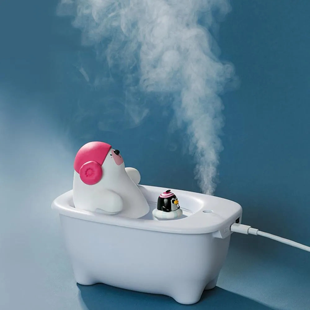 White USB-powered air humidifier and aromatherapy diffuser unit on a desk.