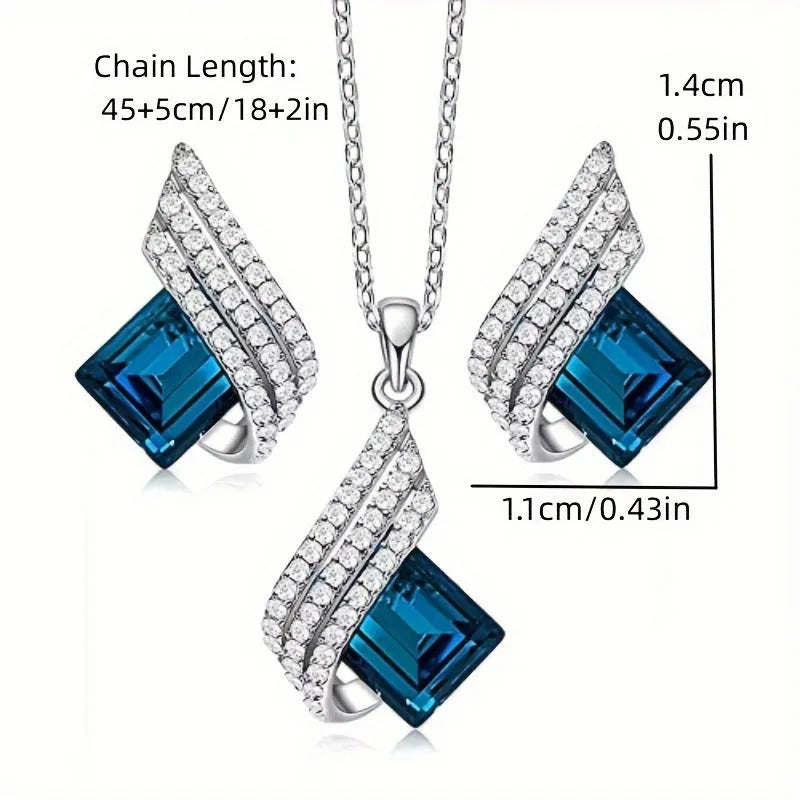 Silver-toned necklace and earrings set with glass pendant on cross chain
