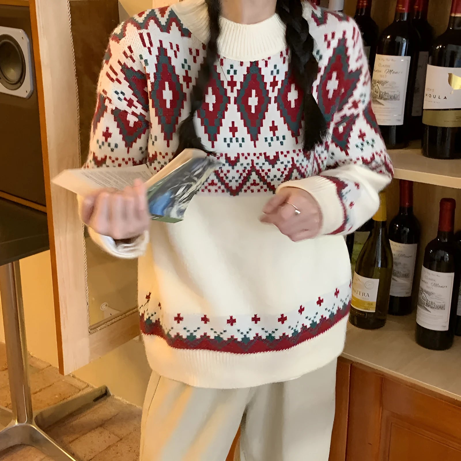 Red and white striped loose-fitting long-sleeved knitted pullover top on a model.