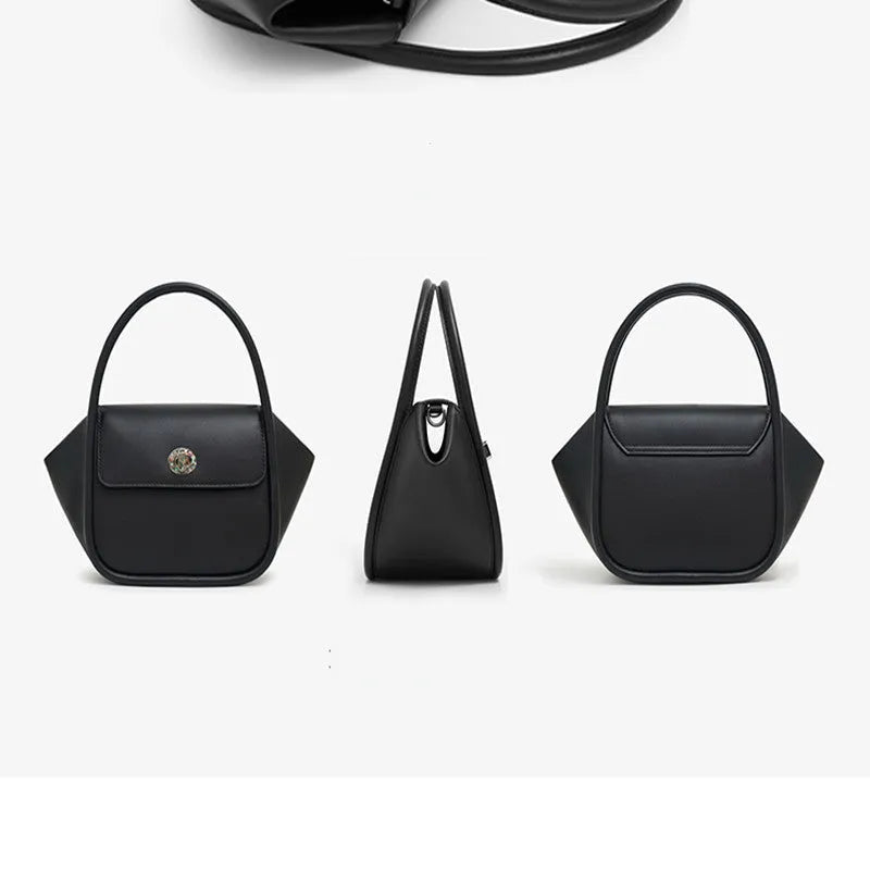 A women's leather wing-shaped tote bag with a metal latch, shown in blue on a cross-body strap.