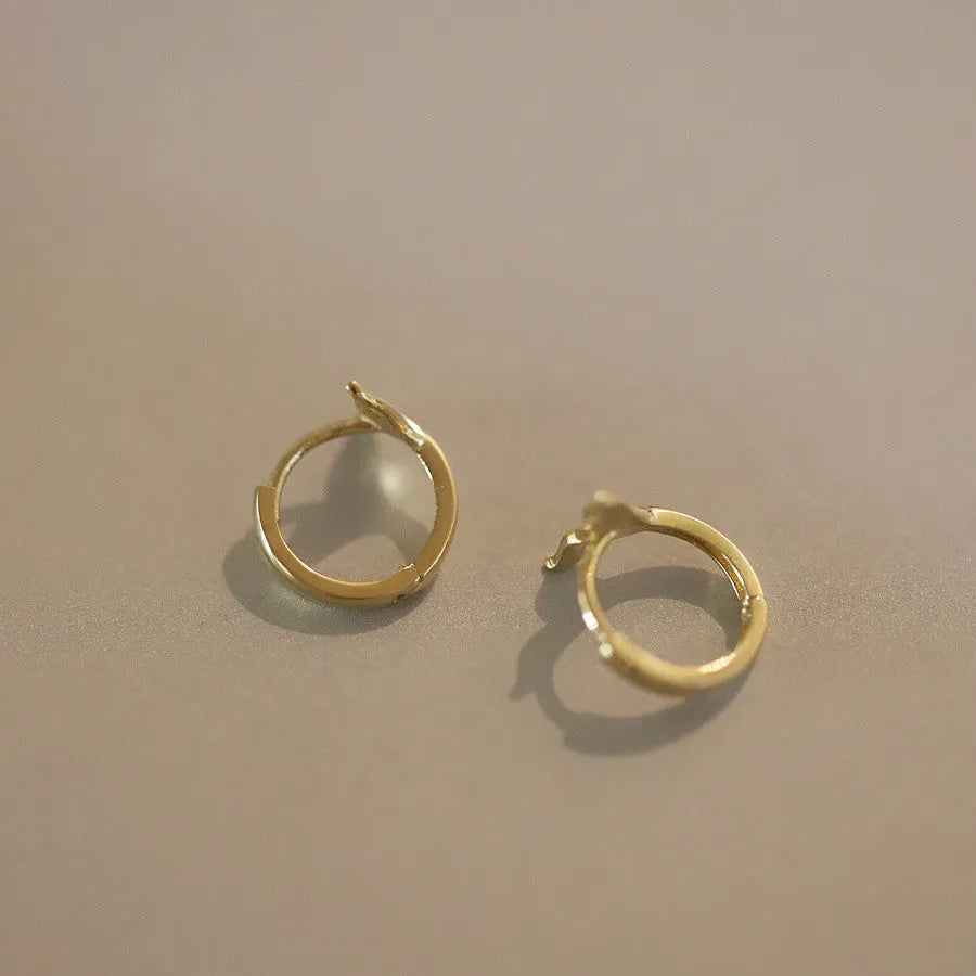 Sterling silver fishtail earrings with gold plating showing 8mm hoop size