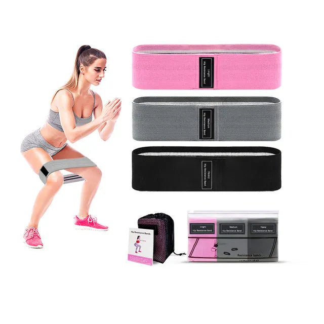 Set of three coloured fabric resistance bands and a net storage bag for home fitness.